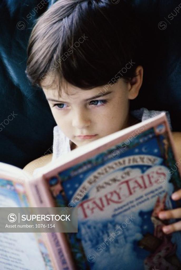 Stock Photo: 1076-154 Close-up of a boy reading a fairy tale book