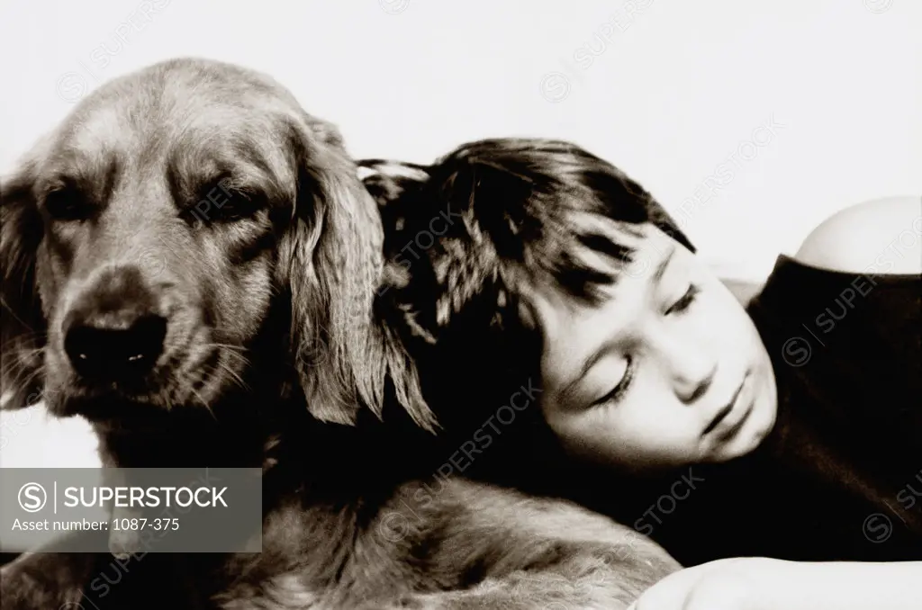 Close-up of a boy sleeping with his dog