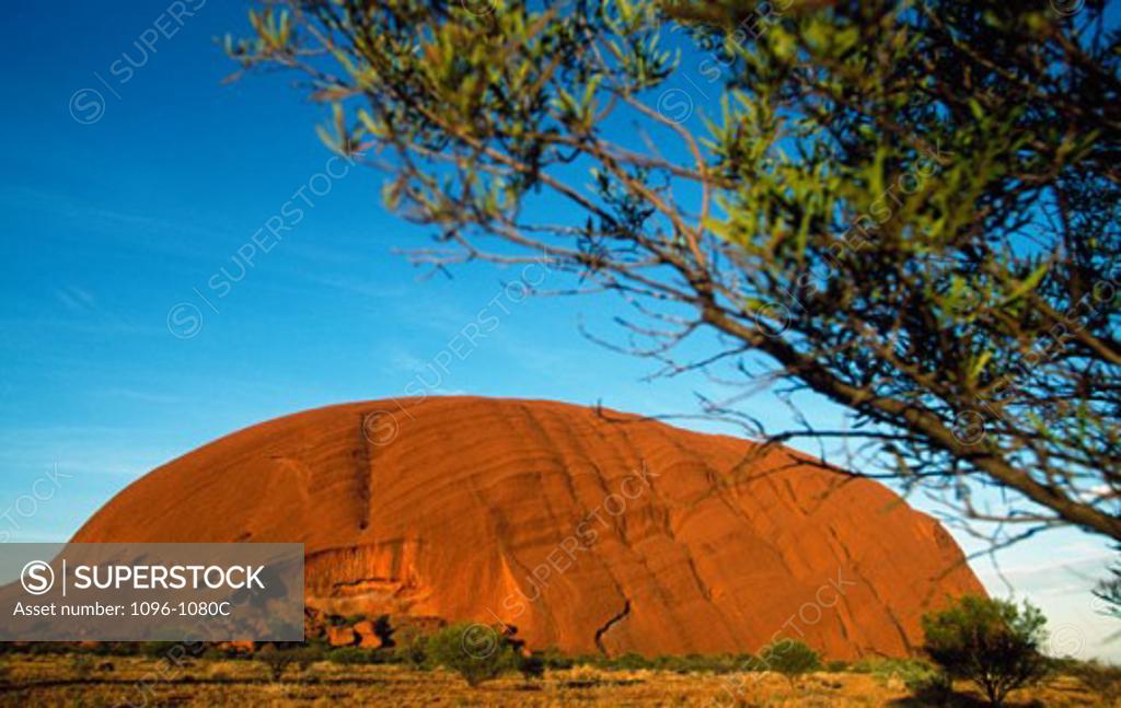 Stock Photo: 1096-1080C Rock formation on a landscape, Ayers Rock, Uluru-Kata Tjuta National Park, Northern Territory, Australia