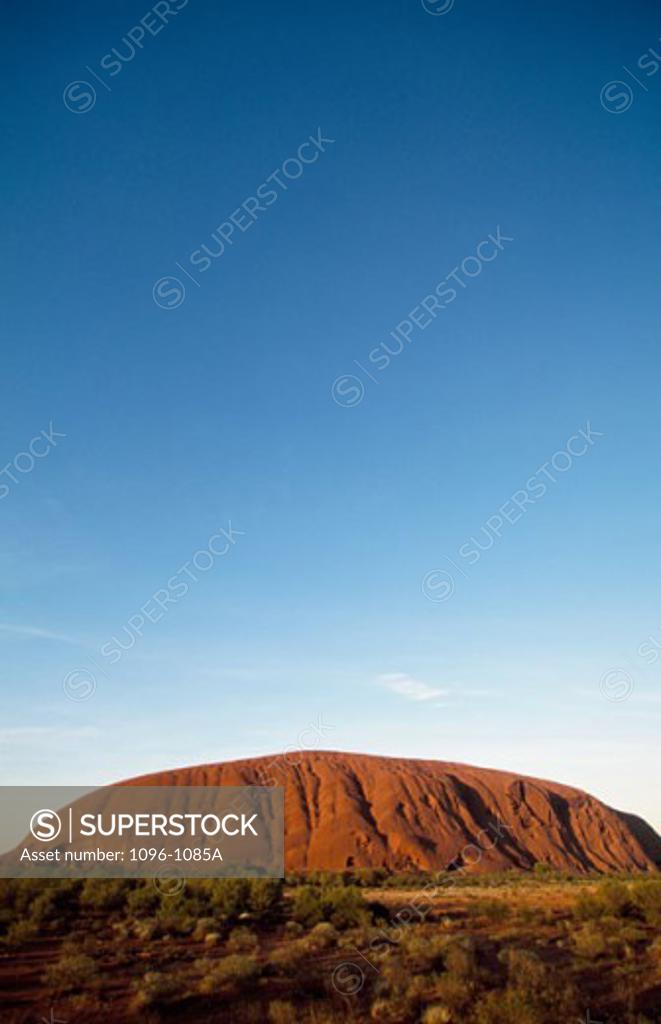 Stock Photo: 1096-1085A Rock formation on a landscape, Ayers Rock, Uluru-Kata Tjuta National Park, Northern Territory, Australia