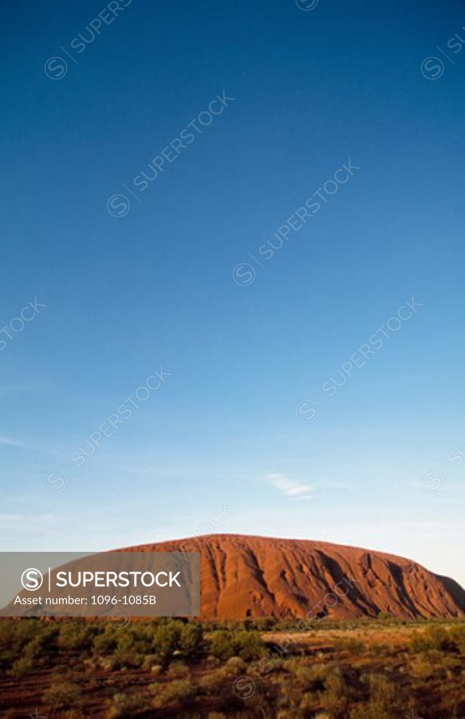 Stock Photo: 1096-1085B Rock formation on a landscape, Ayers Rock, Uluru-Kata Tjuta National Park, Northern Territory, Australia