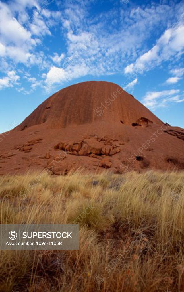 Stock Photo: 1096-1105B Rock formation on a landscape, Ayers Rock, Uluru-Kata Tjuta National Park, Northern Territory, Australia