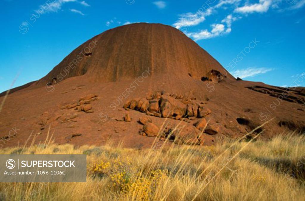 Stock Photo: 1096-1106C Rock formation on a landscape, Ayers Rock, Uluru-Kata Tjuta National Park, Northern Territory, Australia