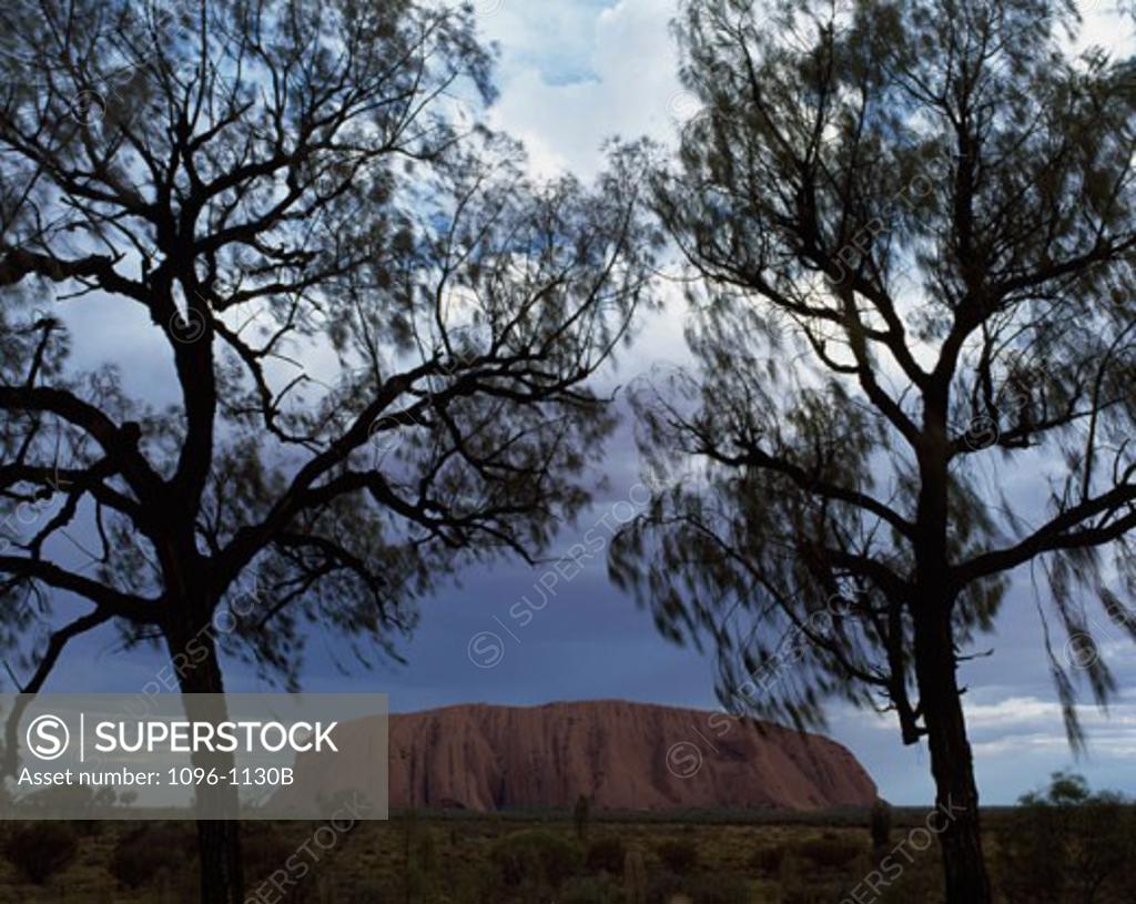 Stock Photo: 1096-1130B Rock formation on a landscape, Ayers Rock, Uluru-Kata Tjuta National Park, Northern Territory, Australia