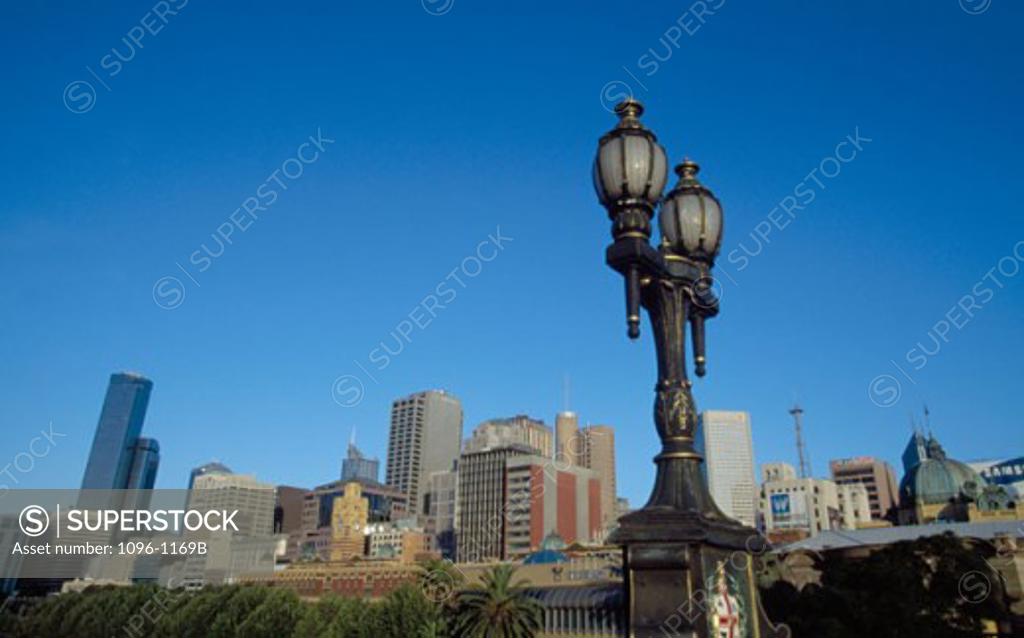Stock Photo: 1096-1169B Low angle view of a lamppost in front of buildings, Melbourne, Victoria, Australia