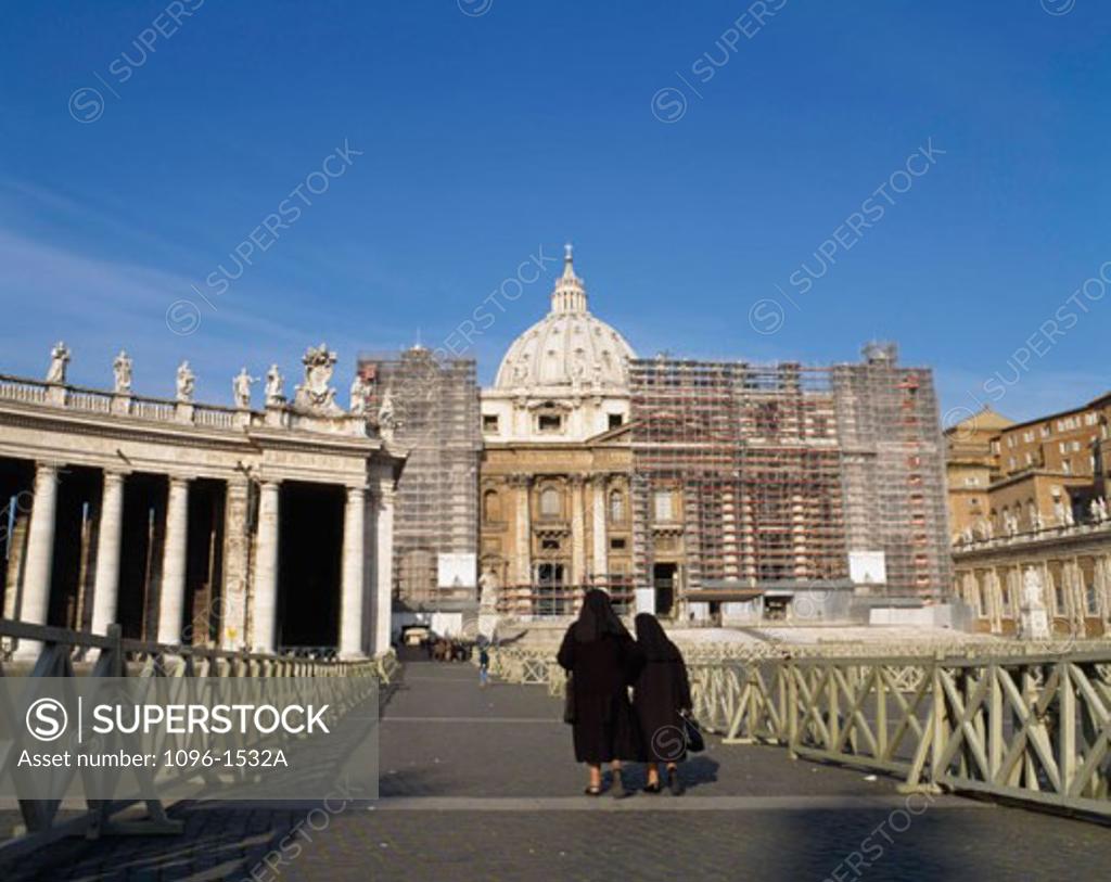 Stock Photo: 1096-1532A Rear view of two women walking in front of a basilica, St. Peter's Basilica, St. Peter's Square, Vatican City