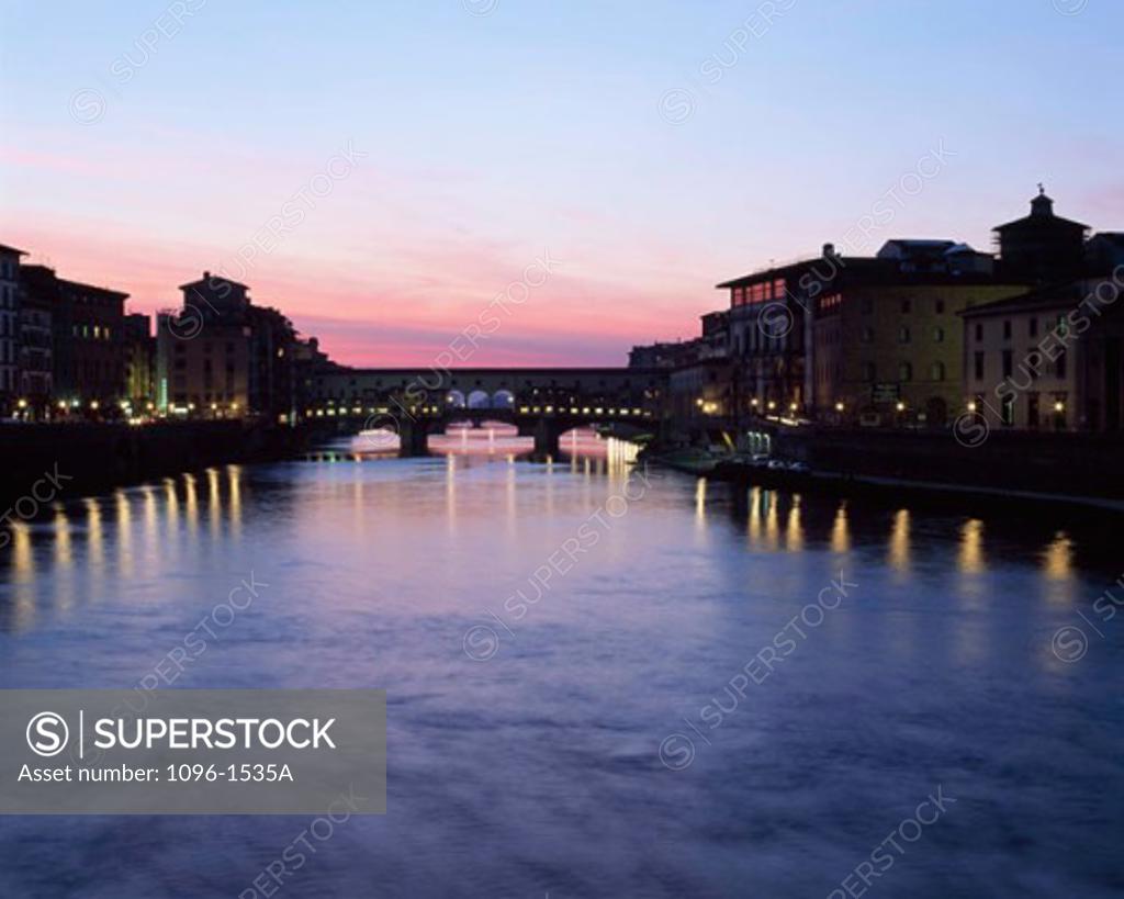 Stock Photo: 1096-1535A Silhouette of a bridge across a river lit up at dusk, Ponte Vecchio, Florence, Italy