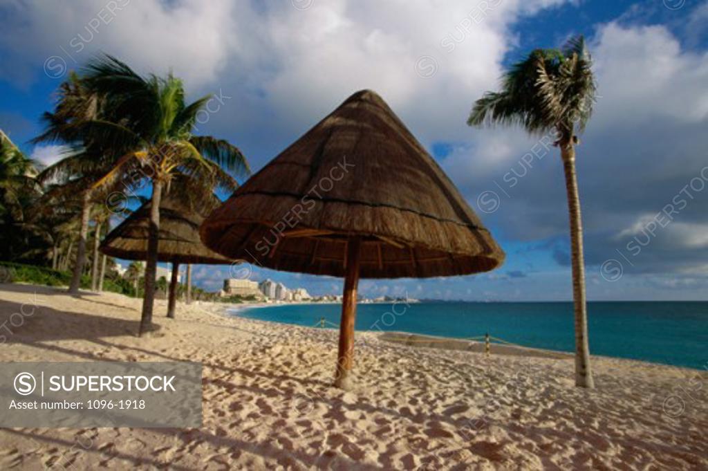 Stock Photo: 1096-1918 Sunshade umbrellas and palm trees on the beach, Cancun, Mexico
