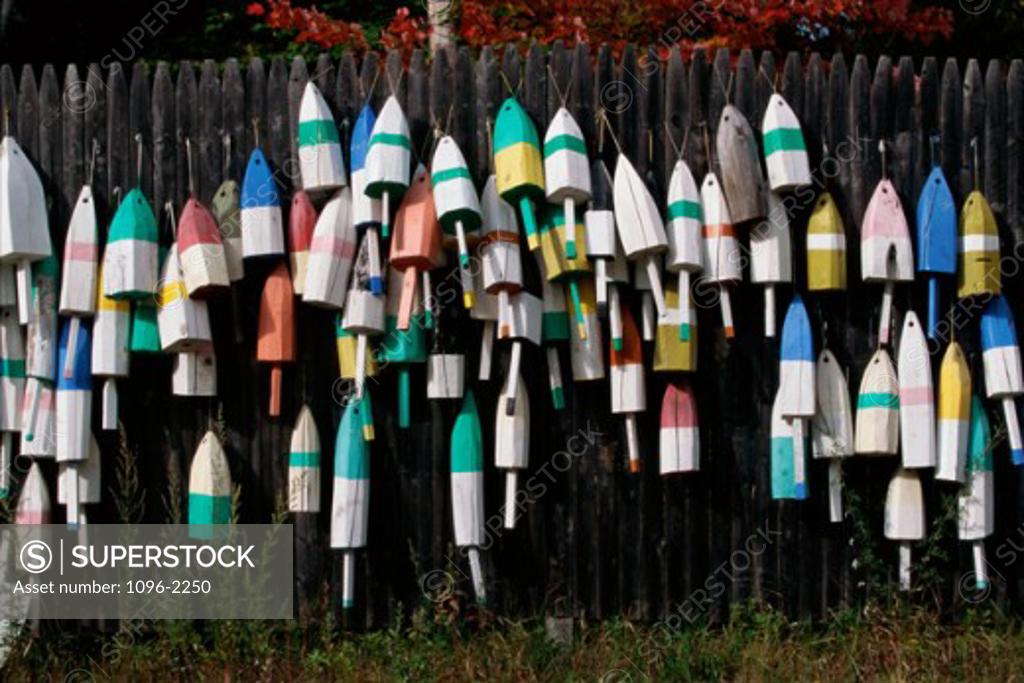 Stock Photo: 1096-2250 Lobster buoys hanging on a fence
