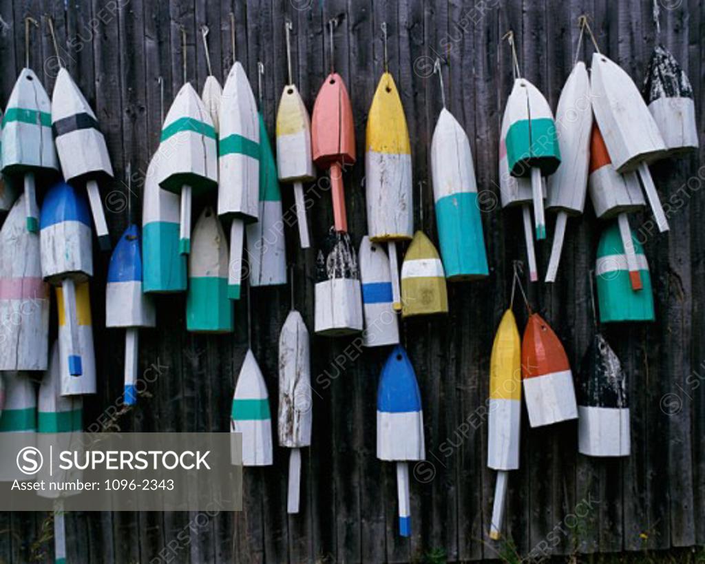 Stock Photo: 1096-2343 Close-up of lobster buoys hanging on a fence