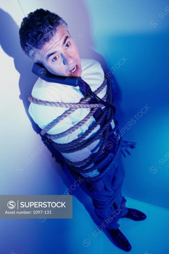 Stock Photo: 1097-131 High angle view of a businessman bound in rope