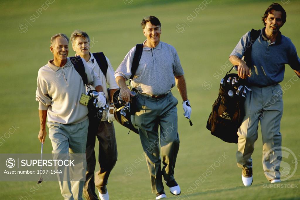 Stock Photo: 1097-154A Four men walking on a golf course