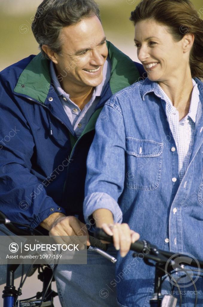 Stock Photo: 1097-159 Mature couple holding bicycles