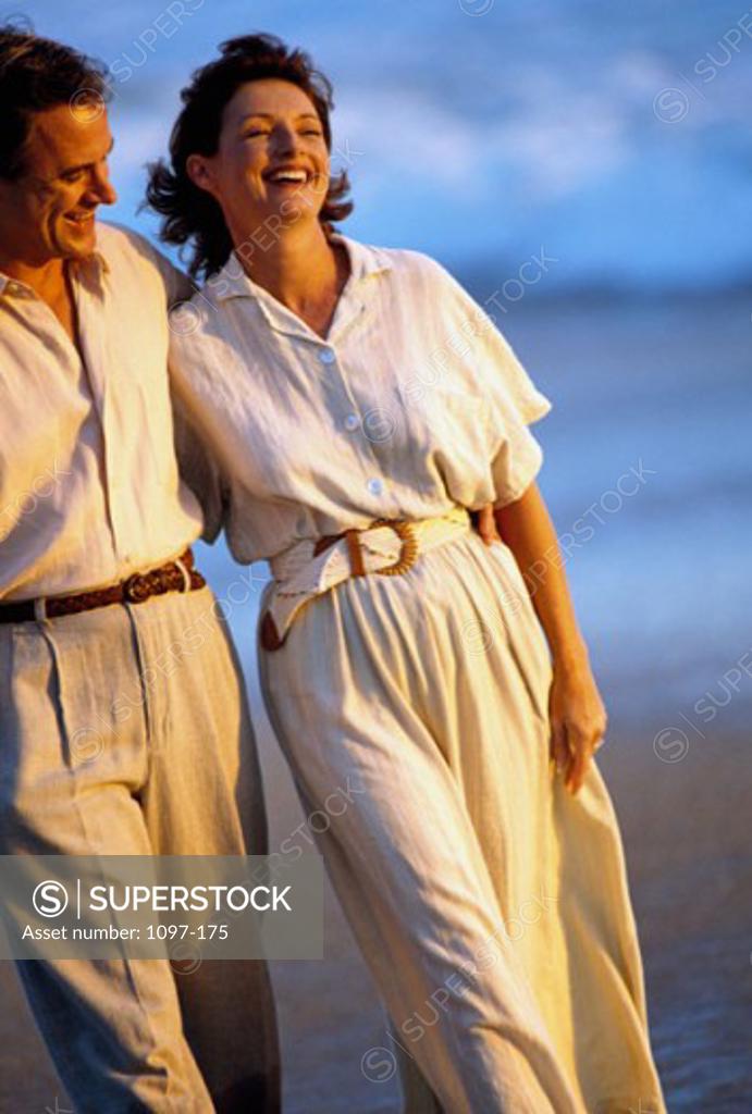 Stock Photo: 1097-175 Mid adult couple walking on the beach