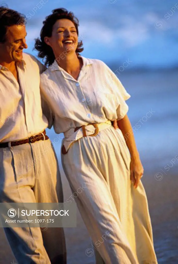 Mid adult couple walking on the beach