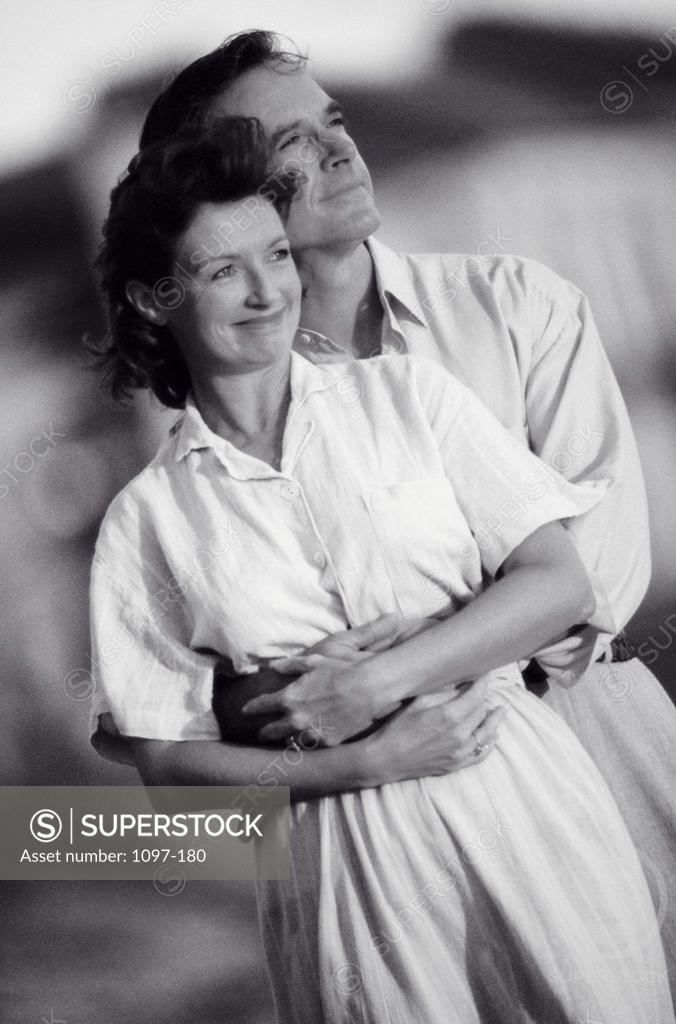 Stock Photo: 1097-180 Mid adult couple embracing each other