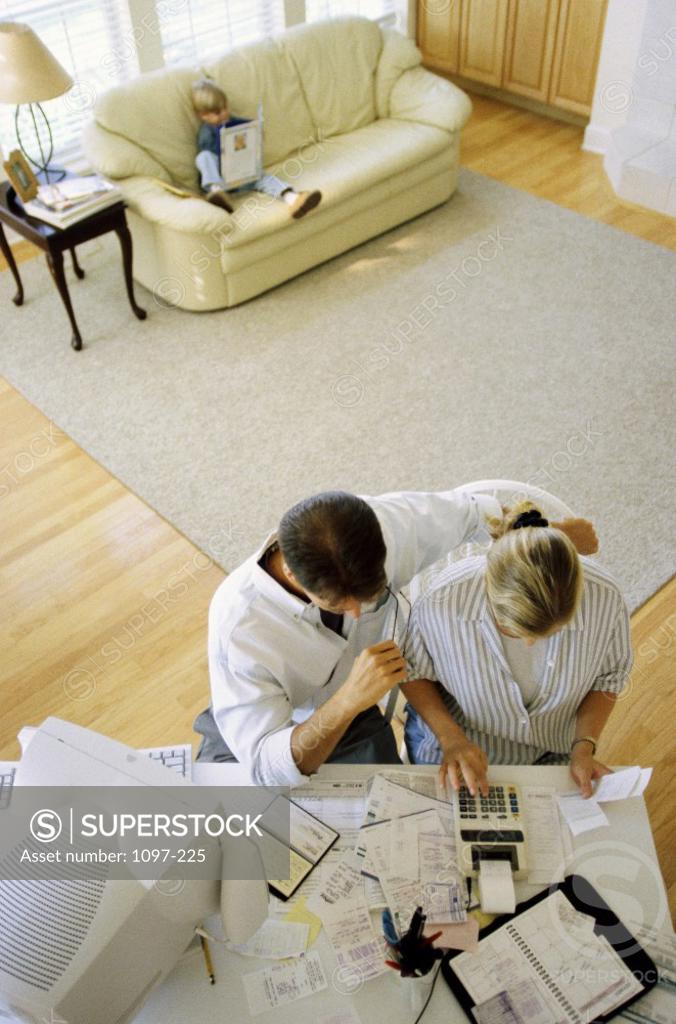 Stock Photo: 1097-225 High angle view of a mid adult couple calculating bills