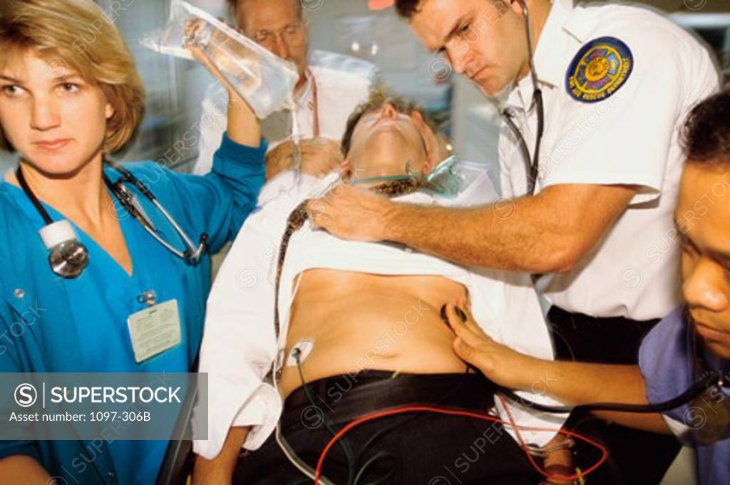 Stock Photo: 1097-306B Four paramedics pushing a patient on a stretcher