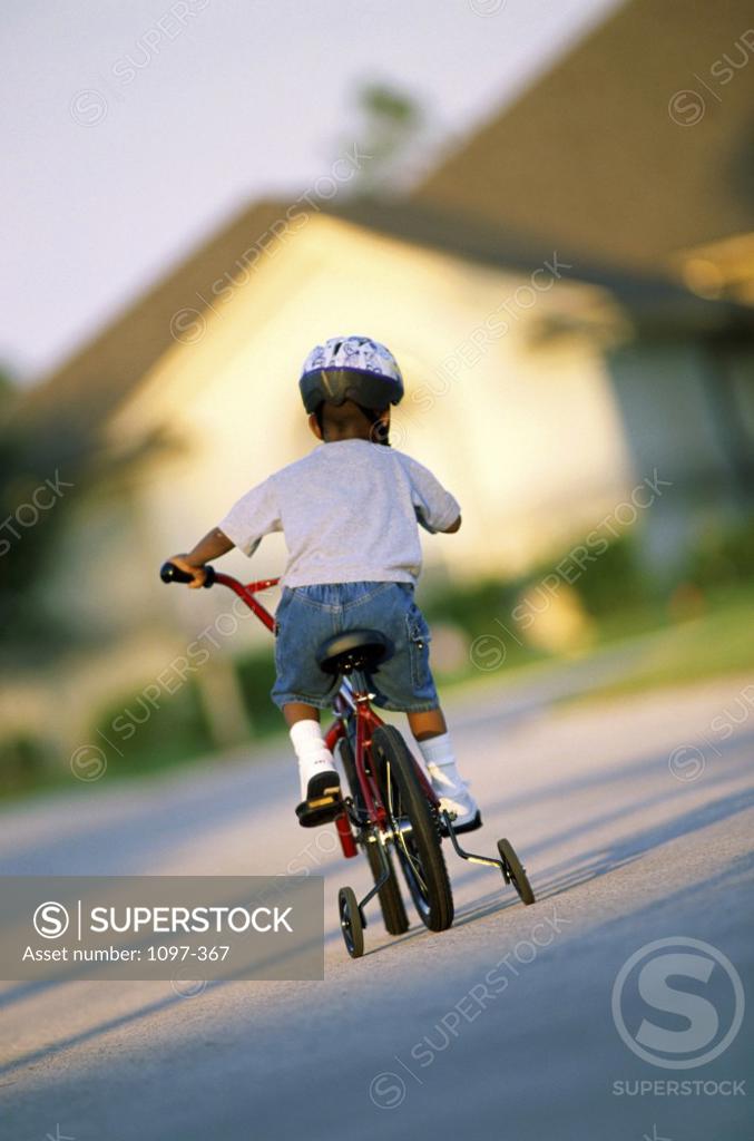 Stock Photo: 1097-367 Rear view of a boy riding a bicycle