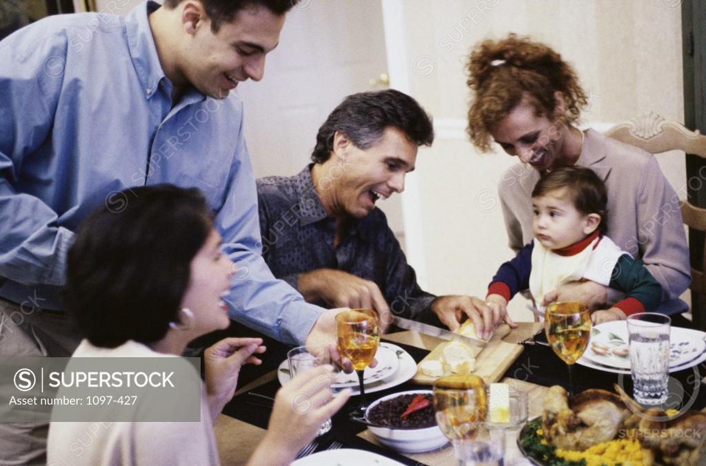 Stock Photo: 1097-427 Family sitting together at a dining table