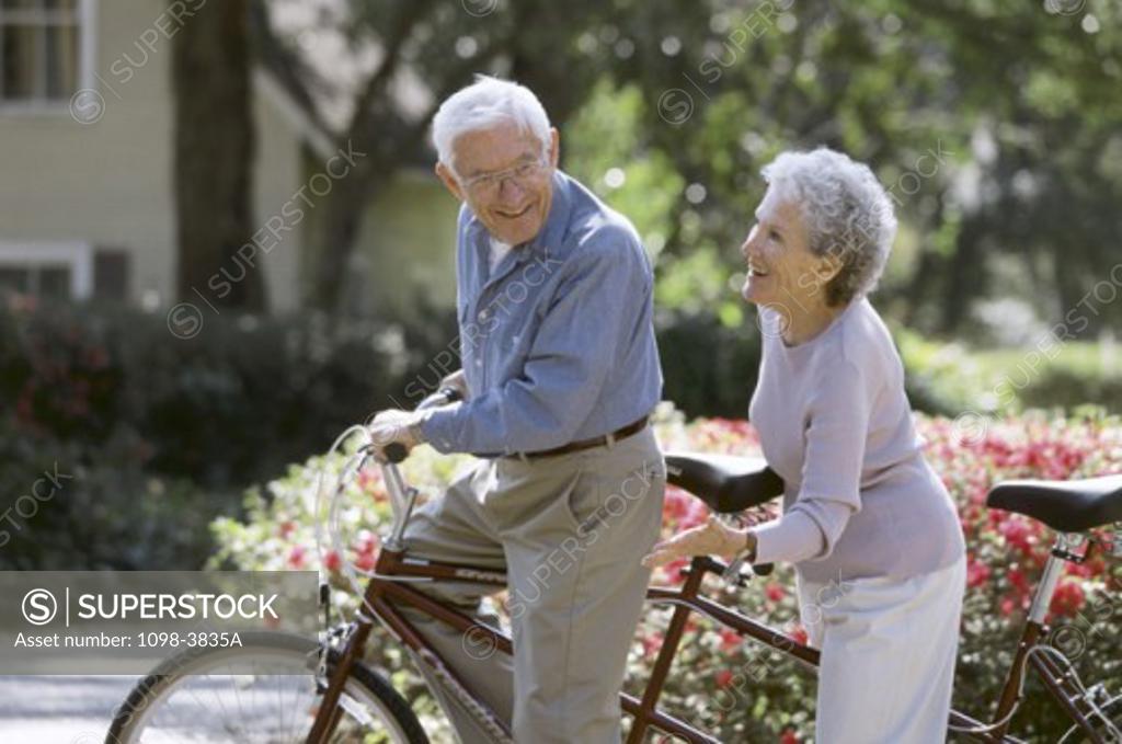 Stock Photo: 1098-3835A Senior couple on a tandem bicycle