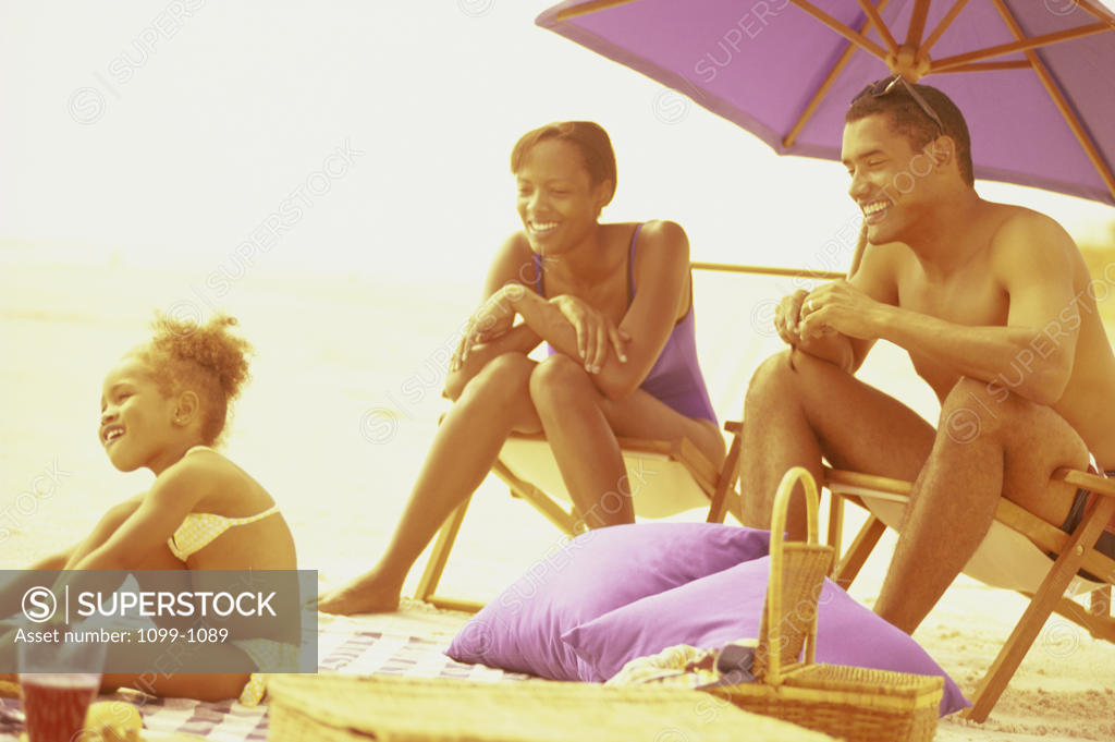 Stock Photo: 1099-1089 Young couple on the beach with their daughter