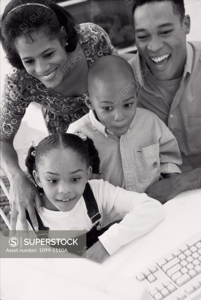 Stock Photo: 1099-1110A High angle view of a family using a computer