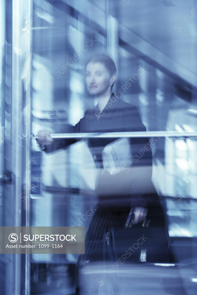 Stock Photo: 1099-1164 Businesswoman leaving from an office