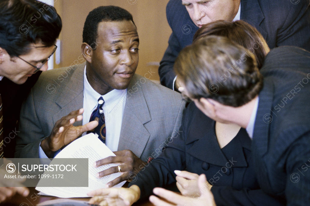 Stock Photo: 1099-1172 Group of business executives talking in an office