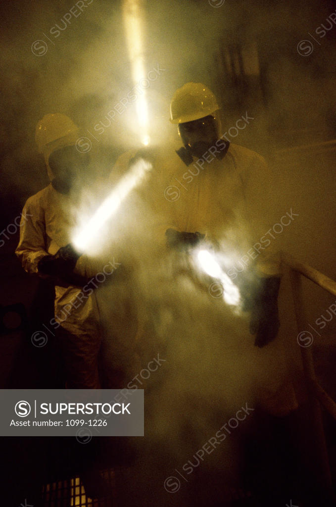 Stock Photo: 1099-1226 Two workers holding flashlights