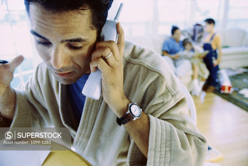 Stock Photo: 1099-1281 Mid adult man talking on a telephone