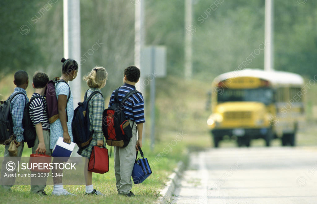 Stock Photo: 1099-1344 Children waiting in line for a school bus