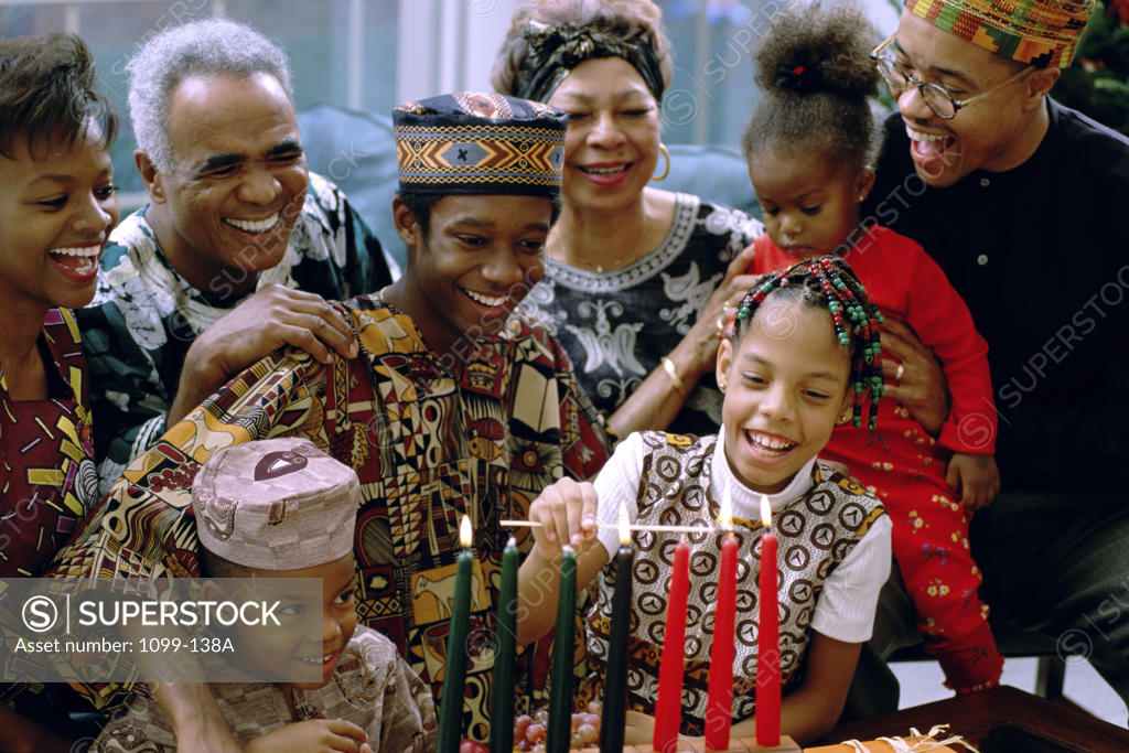 Stock Photo: 1099-138A Family standing behind a lit Mishumaa Saba to celebrate Kwanzaa