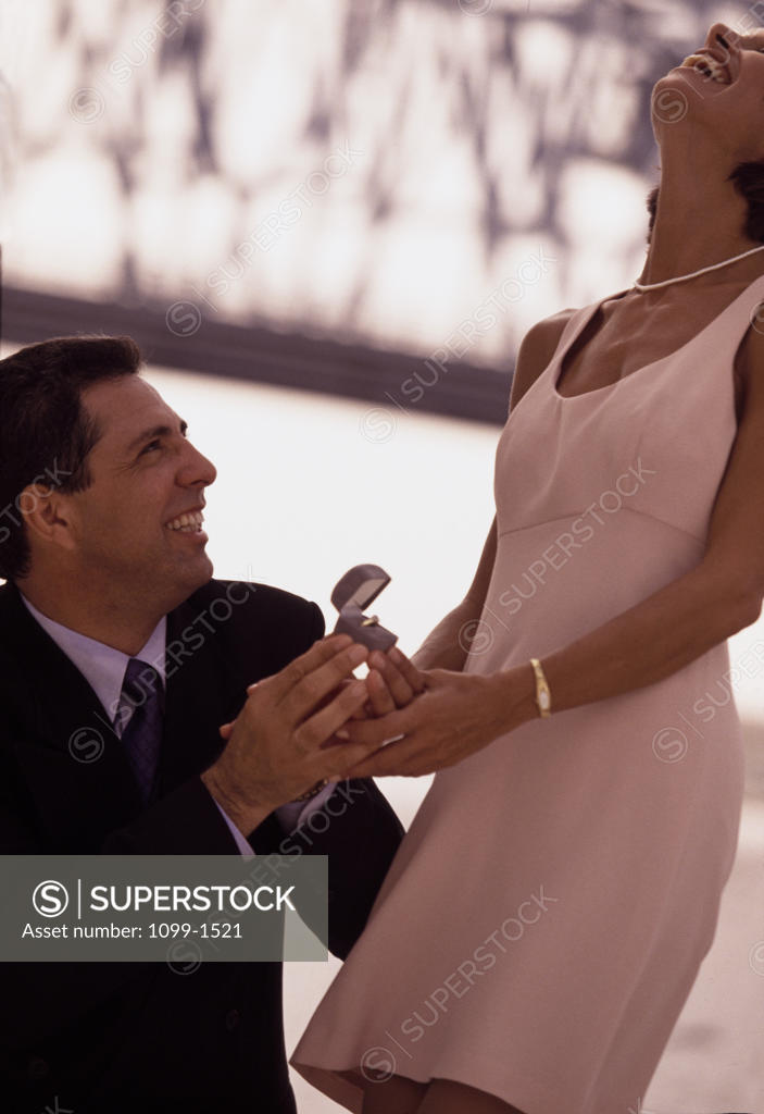 Stock Photo: 1099-1521 Mid adult man proposing to a mid adult woman