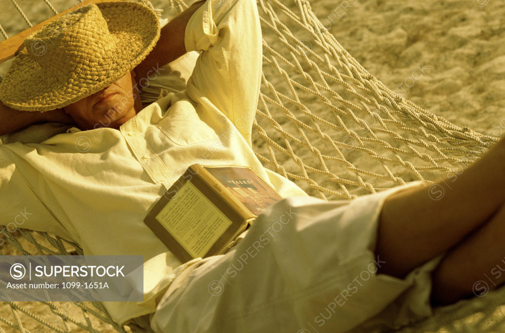 Stock Photo: 1099-1651A Mature man sleeping in a hammock
