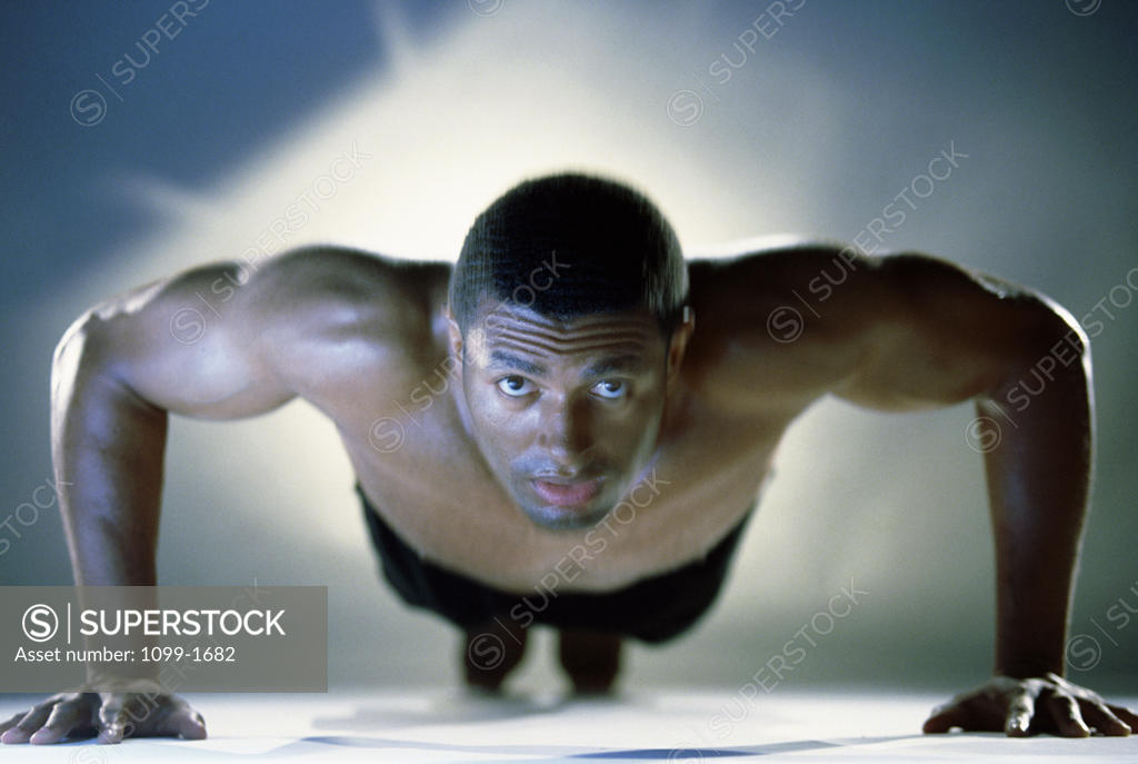 Stock Photo: 1099-1682 Portrait of a mid adult man exercising