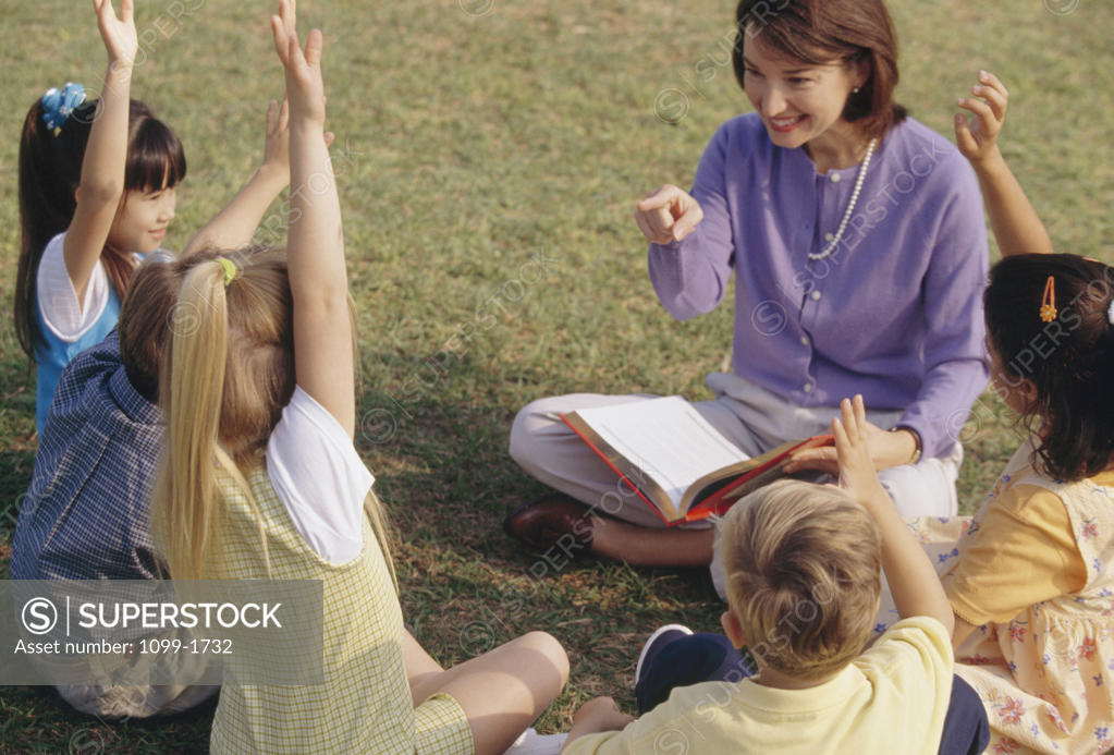 Stock Photo: 1099-1732 Female teacher playing with her students