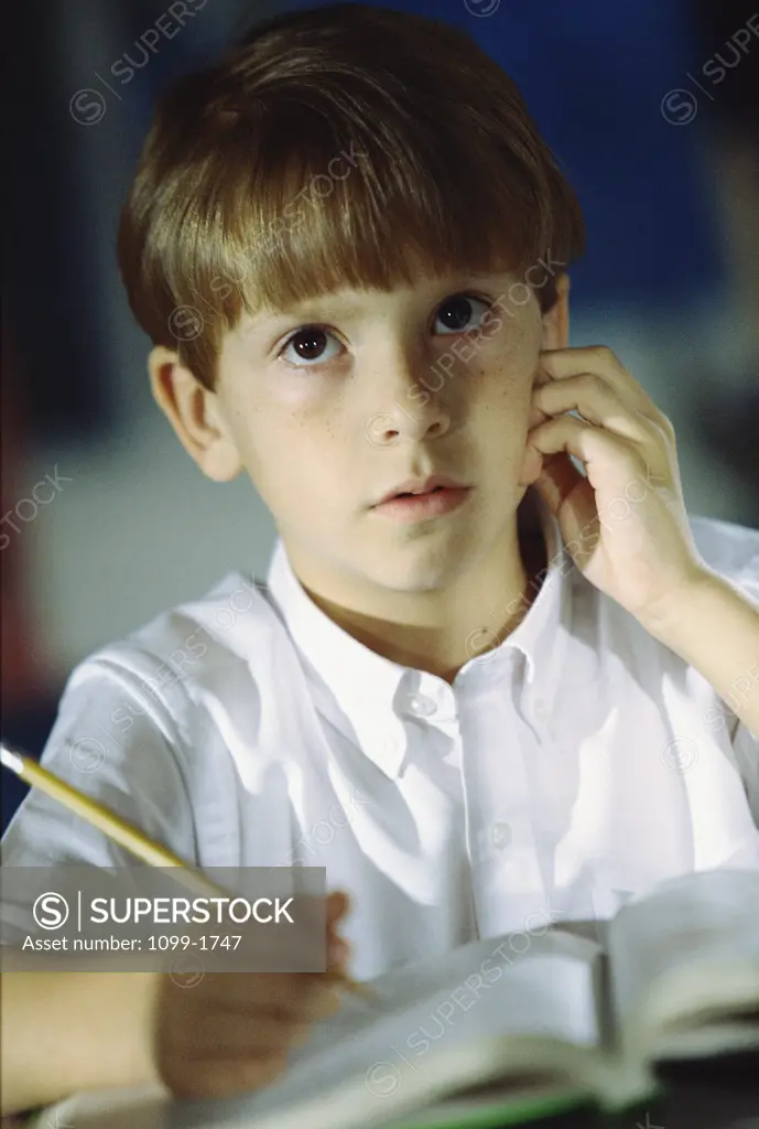 Close-up of a boy studying