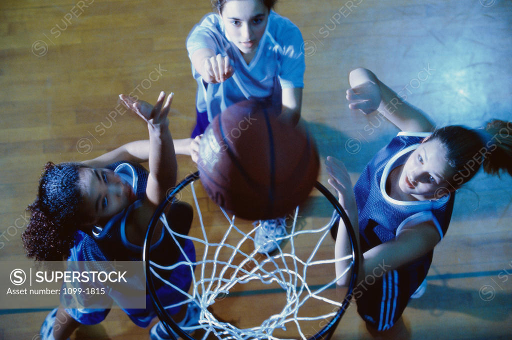 Stock Photo: 1099-1815 High angle view of three young women playing basketball