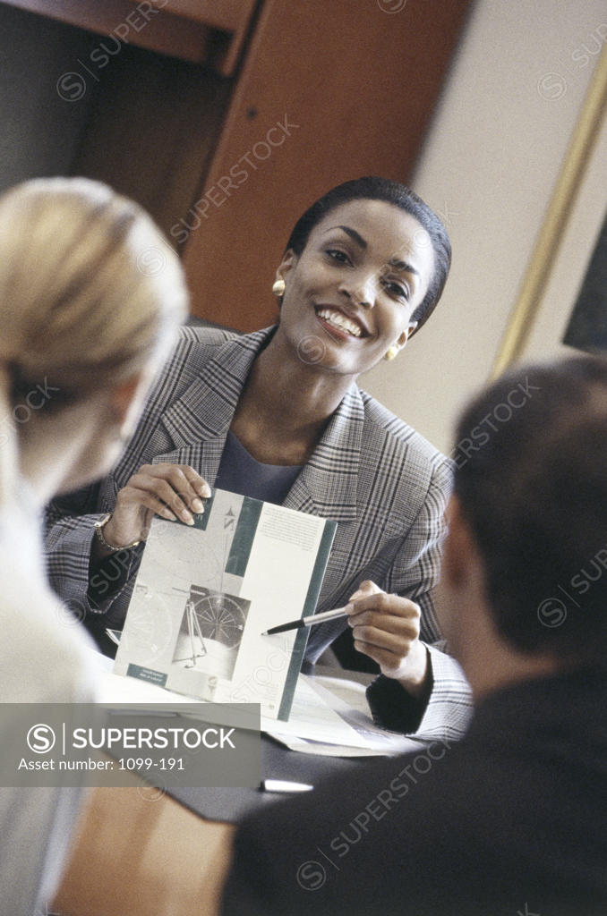 Stock Photo: 1099-191 Two businesswomen and a businessman in a meeting