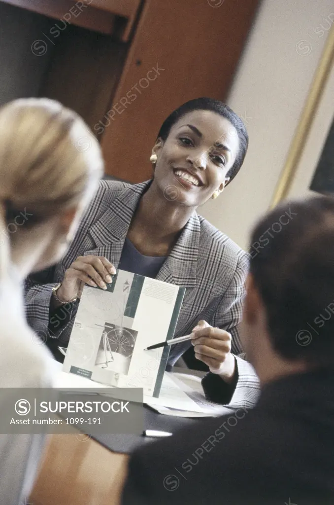Two businesswomen and a businessman in a meeting