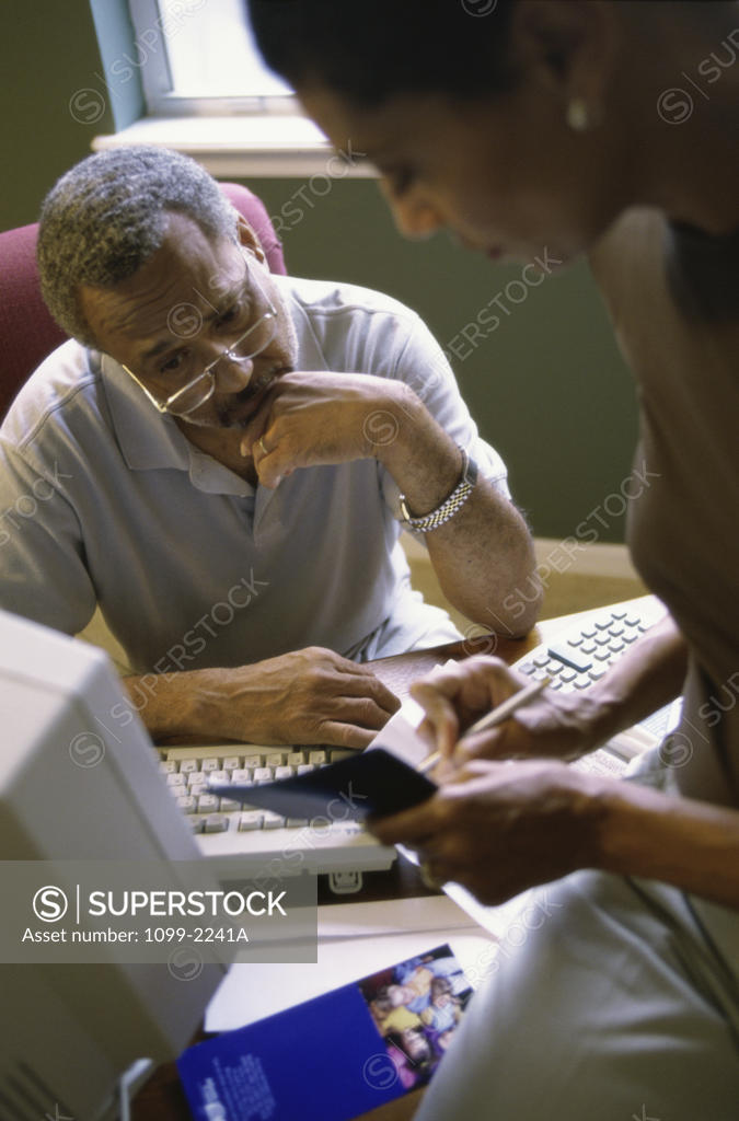Stock Photo: 1099-2241A Close-up of a couple discussing bills