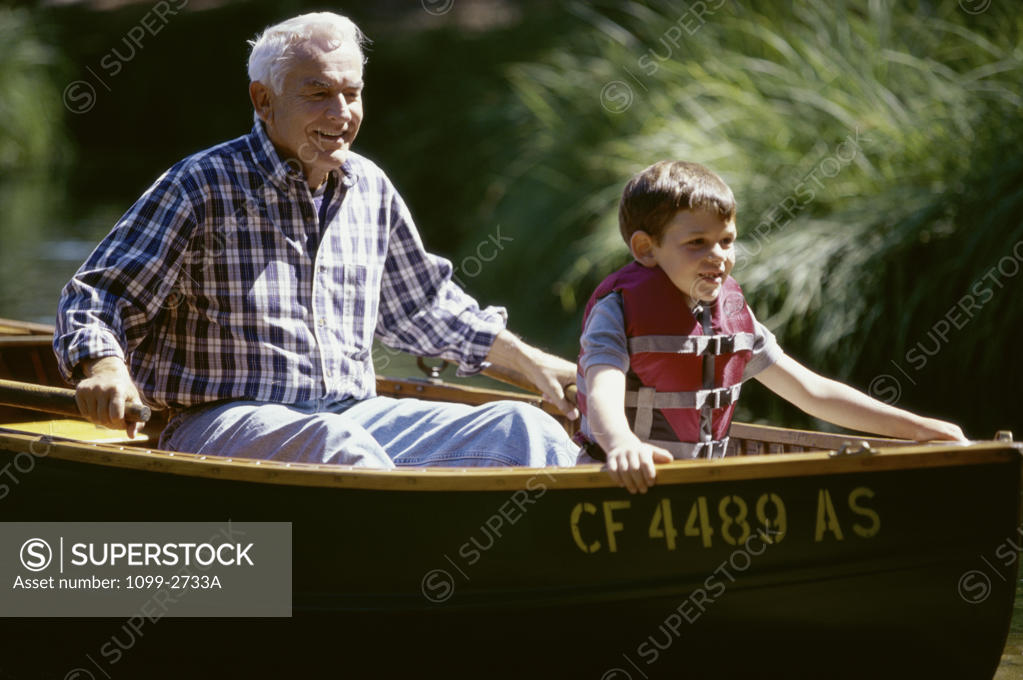 Stock Photo: 1099-2733A Grandfather with his grandson in a boat