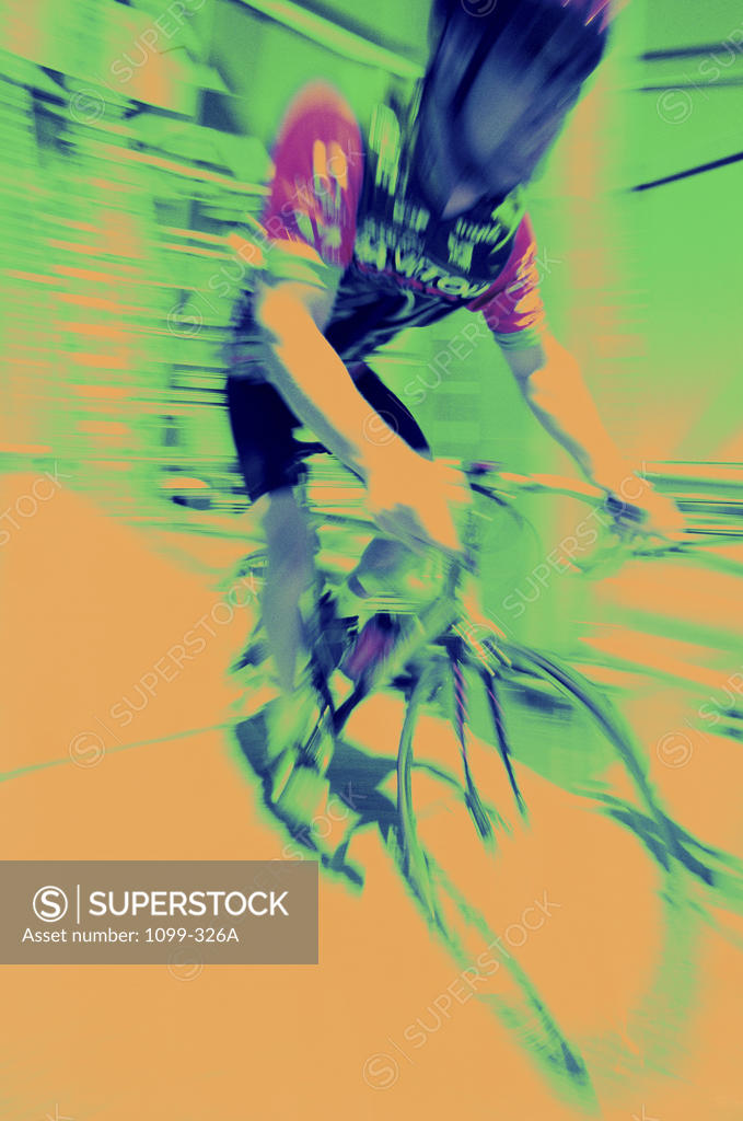 Stock Photo: 1099-326A Young man riding a bicycle