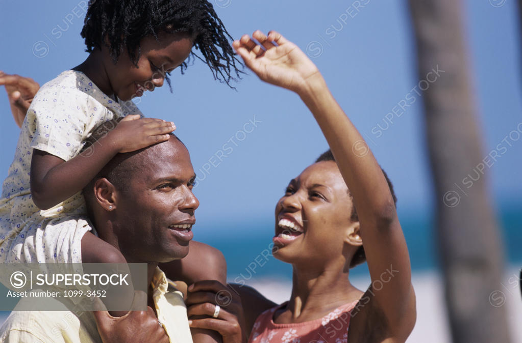 Stock Photo: 1099-3452 Young couple with their child on the beach