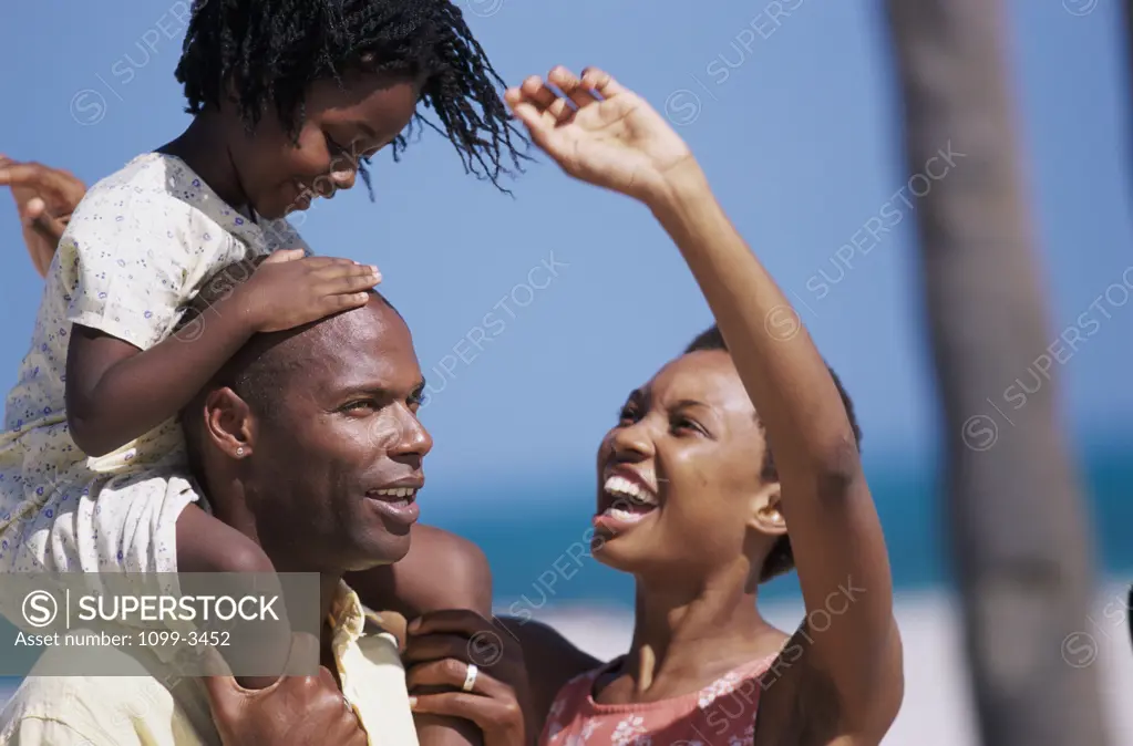 Young couple with their child on the beach