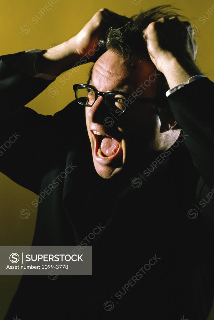 Stock Photo: 1099-3778 Businessman pulling his hair with his mouth open