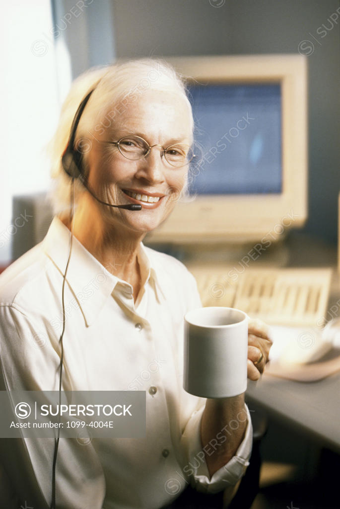 Stock Photo: 1099-4004E Female customer service representative wearing a headset and smiling