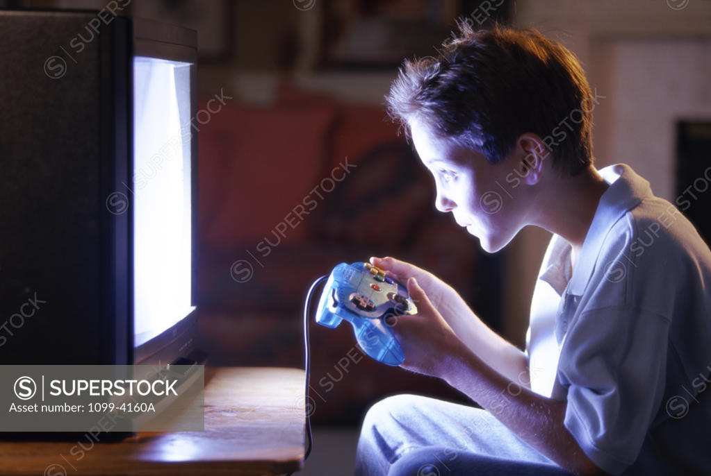 Stock Photo: 1099-4160A Side profile of a teenage boy playing video games