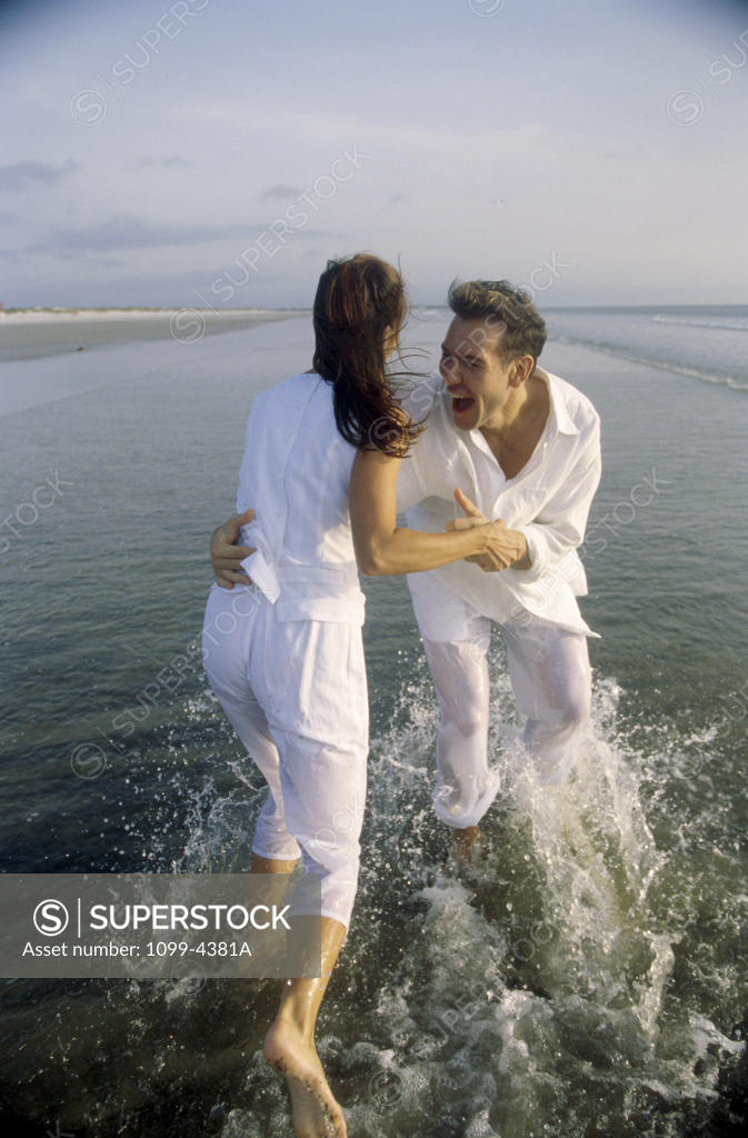 Stock Photo: 1099-4381A Young couple playing on the beach
